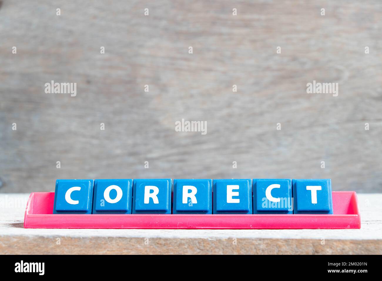 tile-alphabet-letter-with-word-correct-in-red-color-rack-on-wood