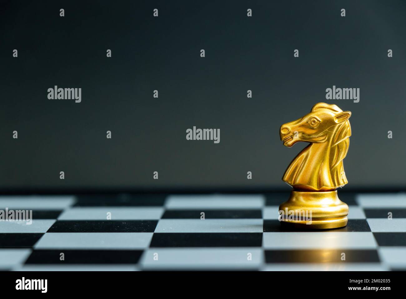 The gold horse, knight chess piece standing with falling silver pawn chess  pieces on chessboard on white background with copy space. Leadership,  winner, competition, and business strategy concept. Photos