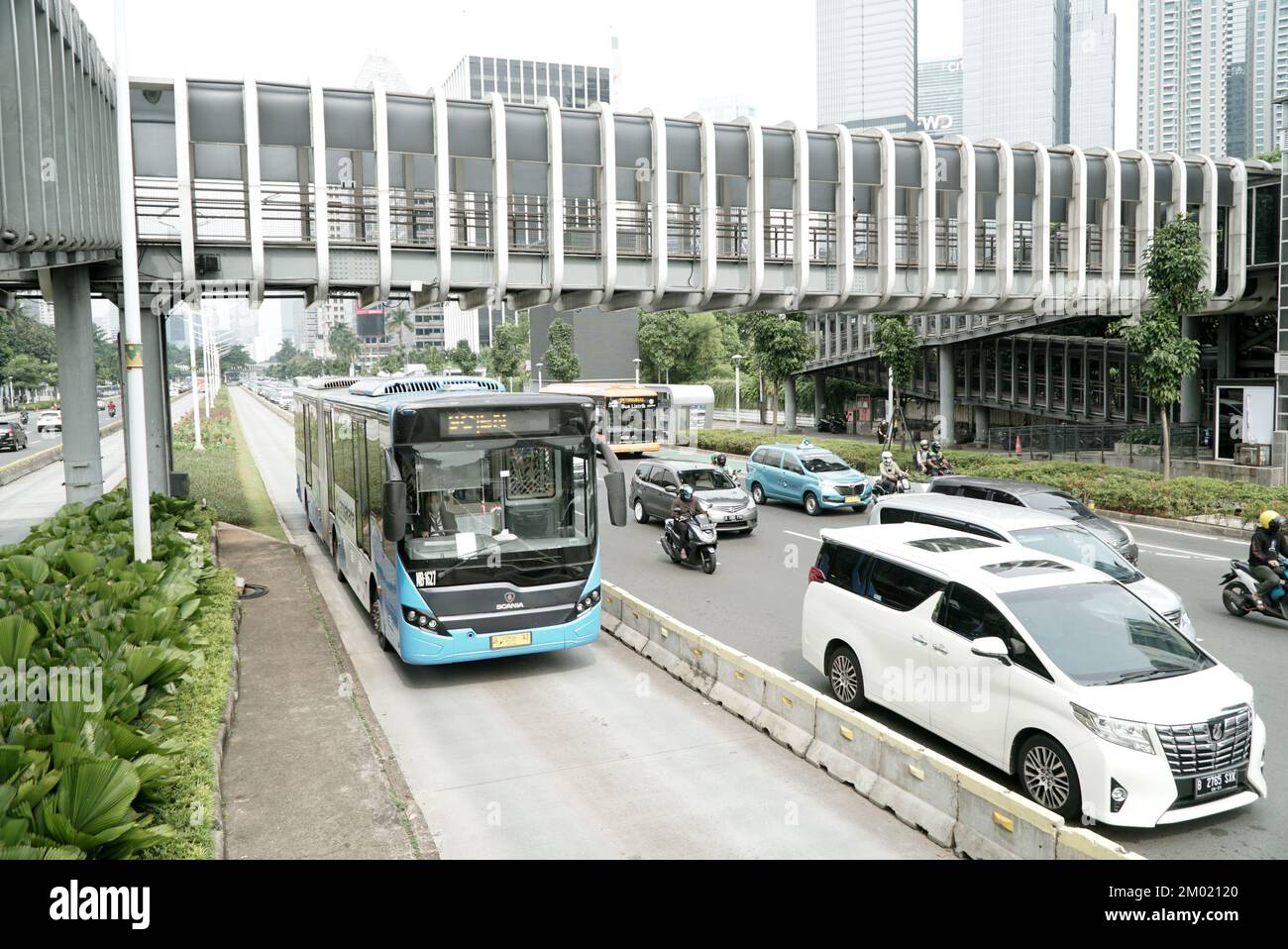 Trans Jakarta bus in bus way line, at the rush hour traffic. Location in business district Sudirman Street Jakarta, Indonesia Stock Photo
