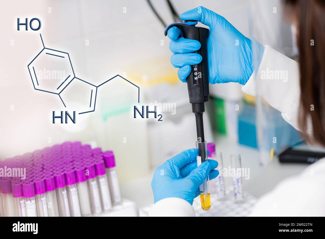 Conceptual image showing pharmaceutical research and the chemical structure of serotonin. Stock Photo