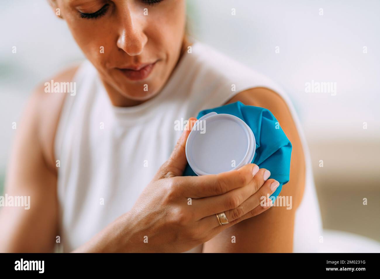 Woman holding cold press onto arm. Stock Photo