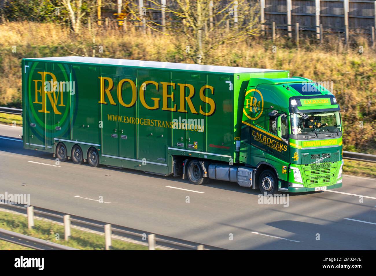 ERM. E.M. ROGERS, E.M. ROGERS (TRANSPORT) LIMITED with Kassbohrer flatbed trailers. Delivery truck on the M6 motorway, UK Stock Photo