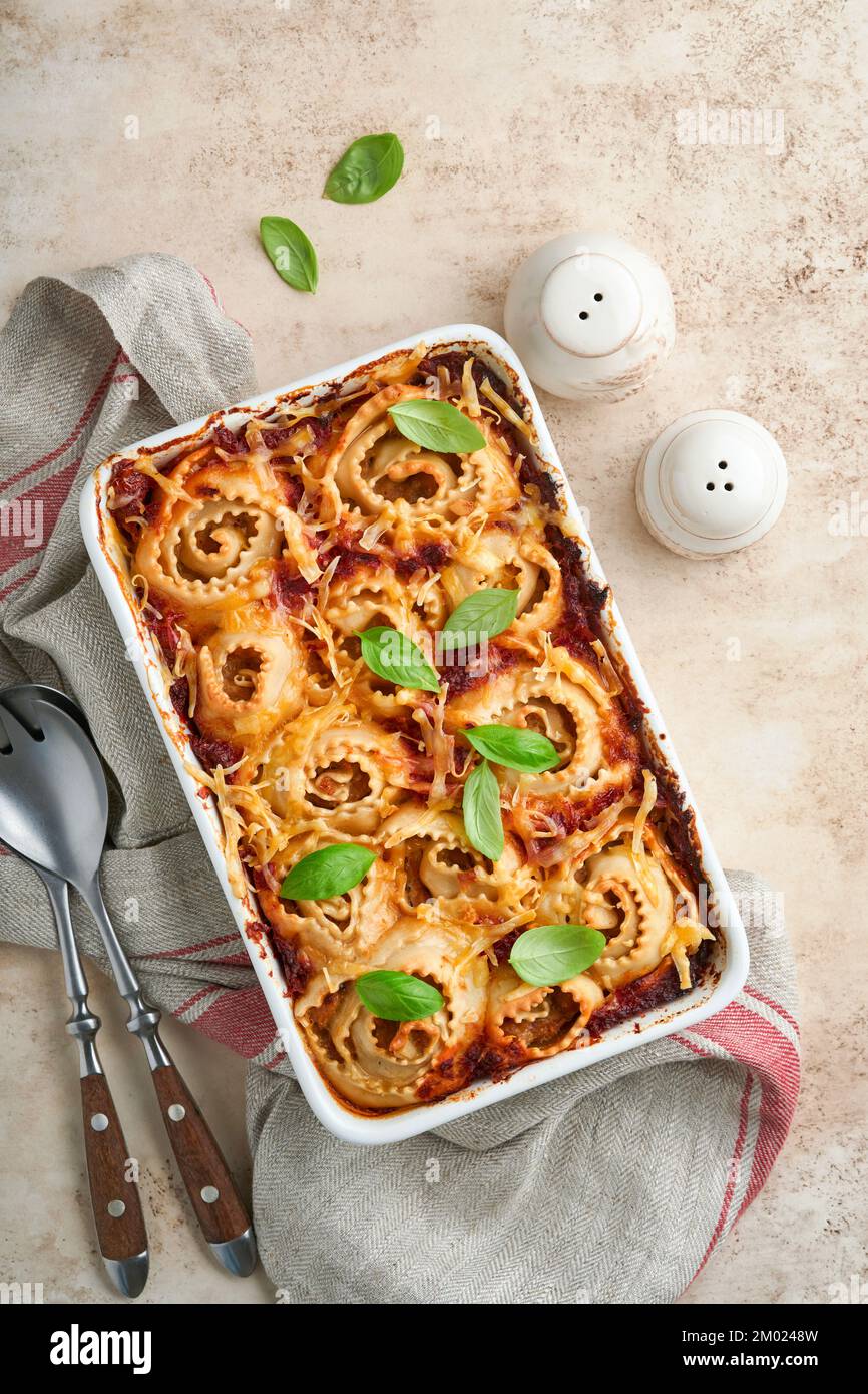 lasagna in an aluminum pan, spatula taking a piece of the pan, selective  focus Stock Photo - Alamy