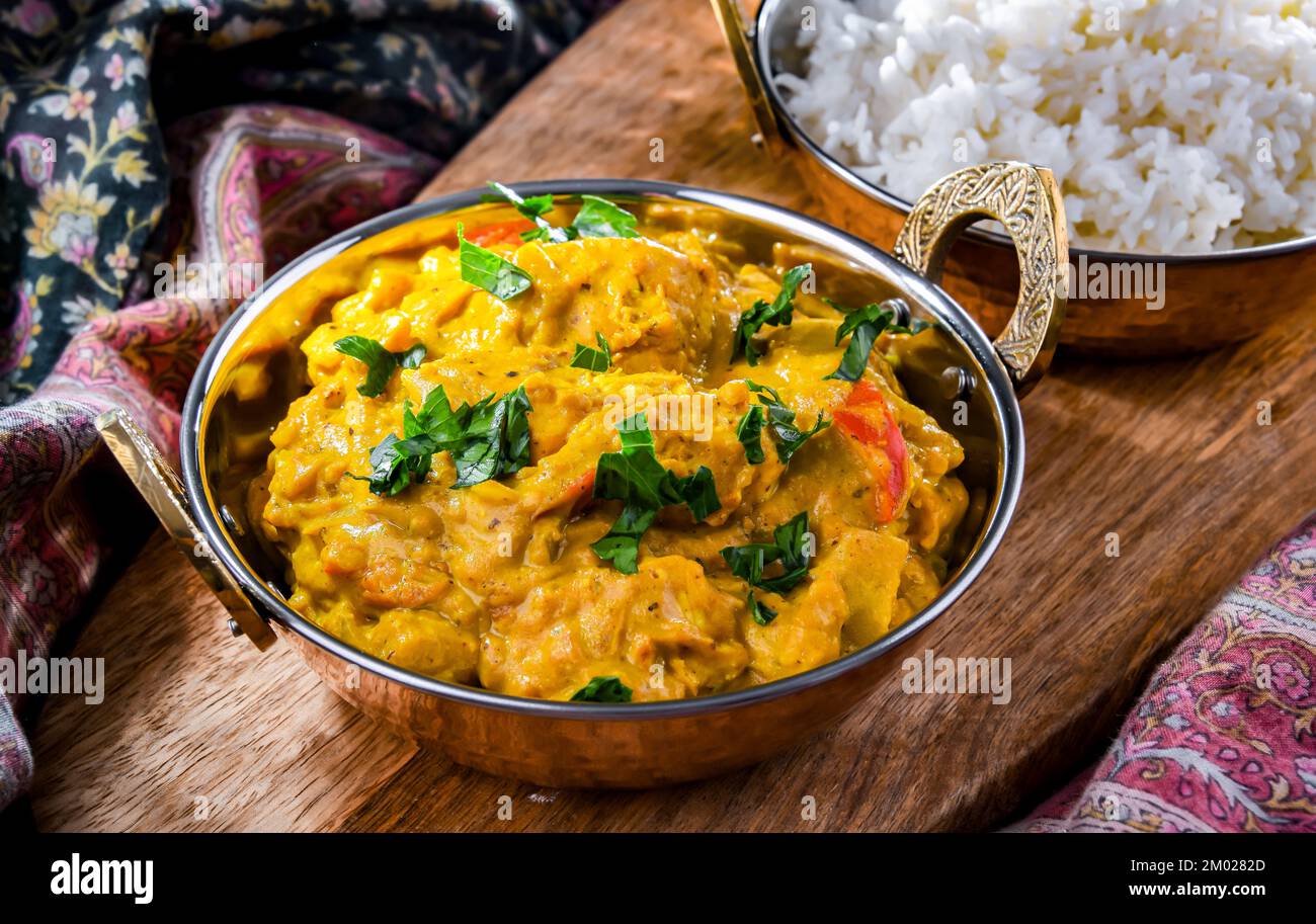 Curry chicken with rice served in original indian karahi pots Stock