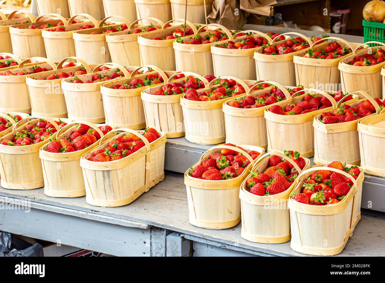 Baskets of strawberries at a farmers' market. Fresh red strawberries