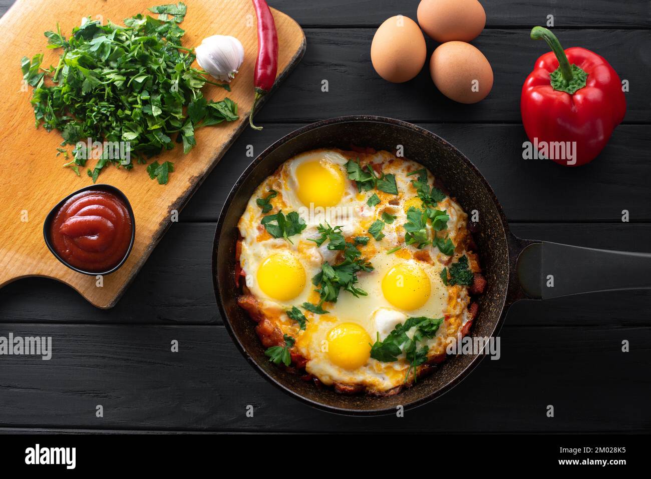 Ingredients for making shakshuka. Shakshuka in an iron skillet with