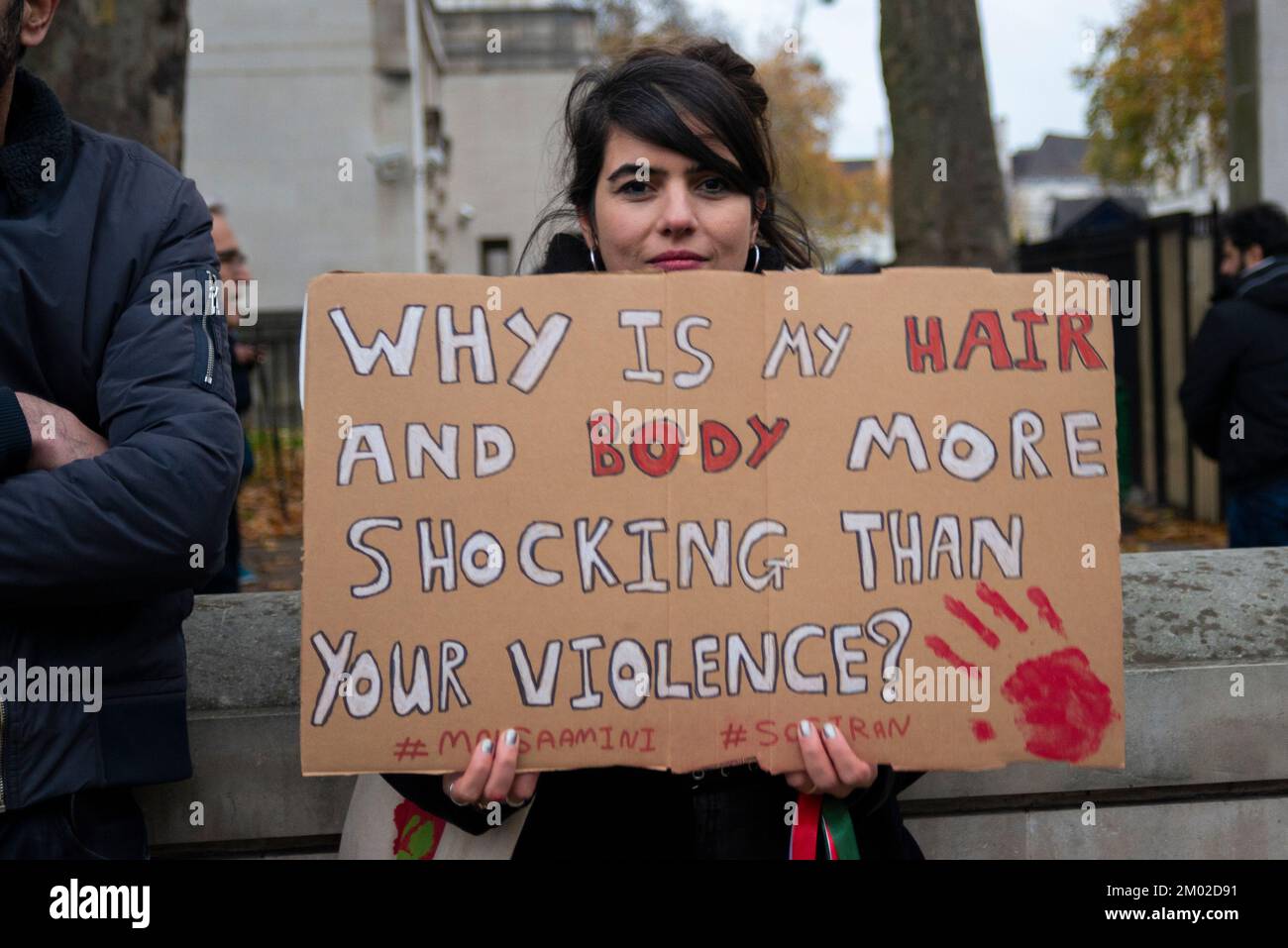 Westminster, London, UK. 3rd Dec, 2022. Protesters have gathered in Trafalgar Square and opposite Downing Street in Whitehall to protest against the actions of the Iranian regime. Branded Iranian Women Revolution, the aim is to replace Iran's extremist Islamic government with a democratic government. Female protester with placard Stock Photo