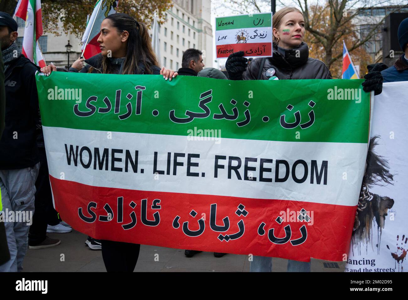 Westminster, London, UK. 3rd Dec, 2022. Protesters have gathered in Trafalgar Square and opposite Downing Street in Whitehall to protest against the actions of the Iranian regime. Branded Iranian Women Revolution, the aim is to replace Iran's extremist Islamic government with a democratic government. Women, life, freedom message flag Stock Photo