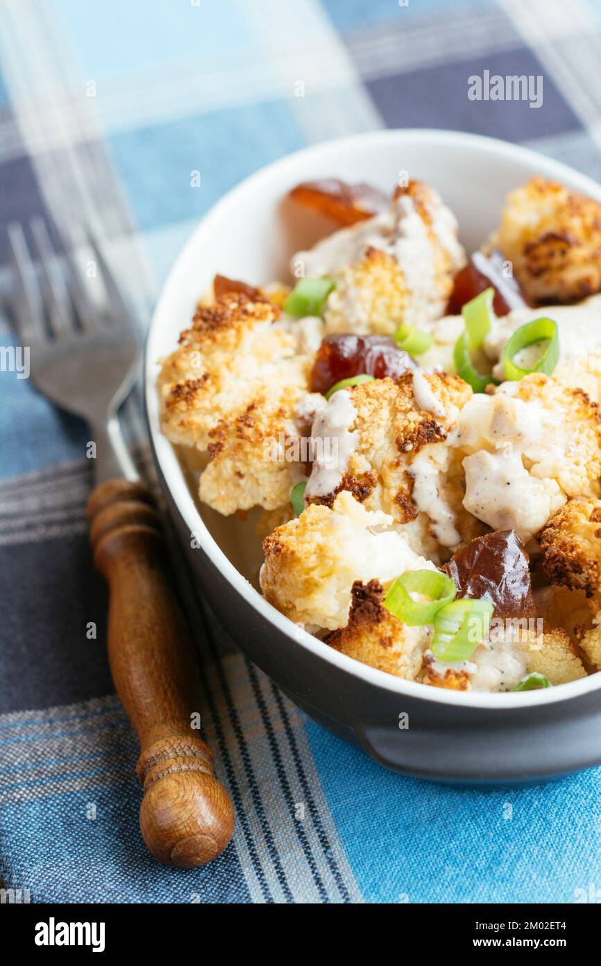 Roasted Cauliflower with Dates and Tahini Dressing Stock Photo - Alamy