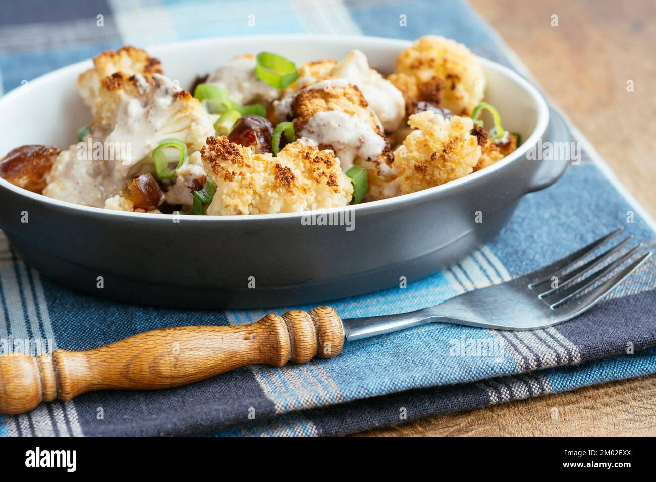 Roasted Cauliflower with Dates and Tahini Dressing Stock Photo - Alamy