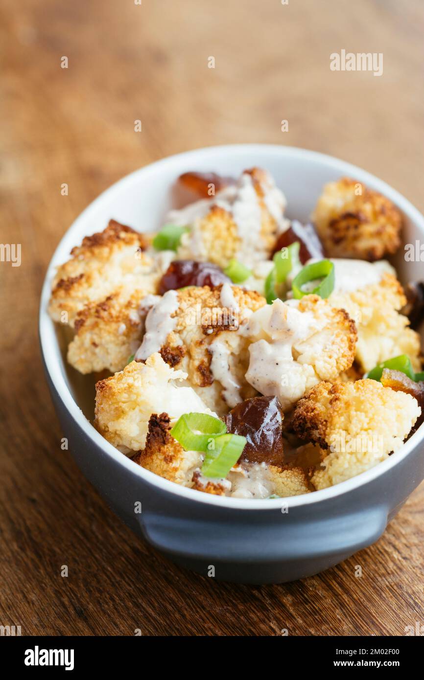Roasted Cauliflower with Dates and Tahini Dressing Stock Photo - Alamy