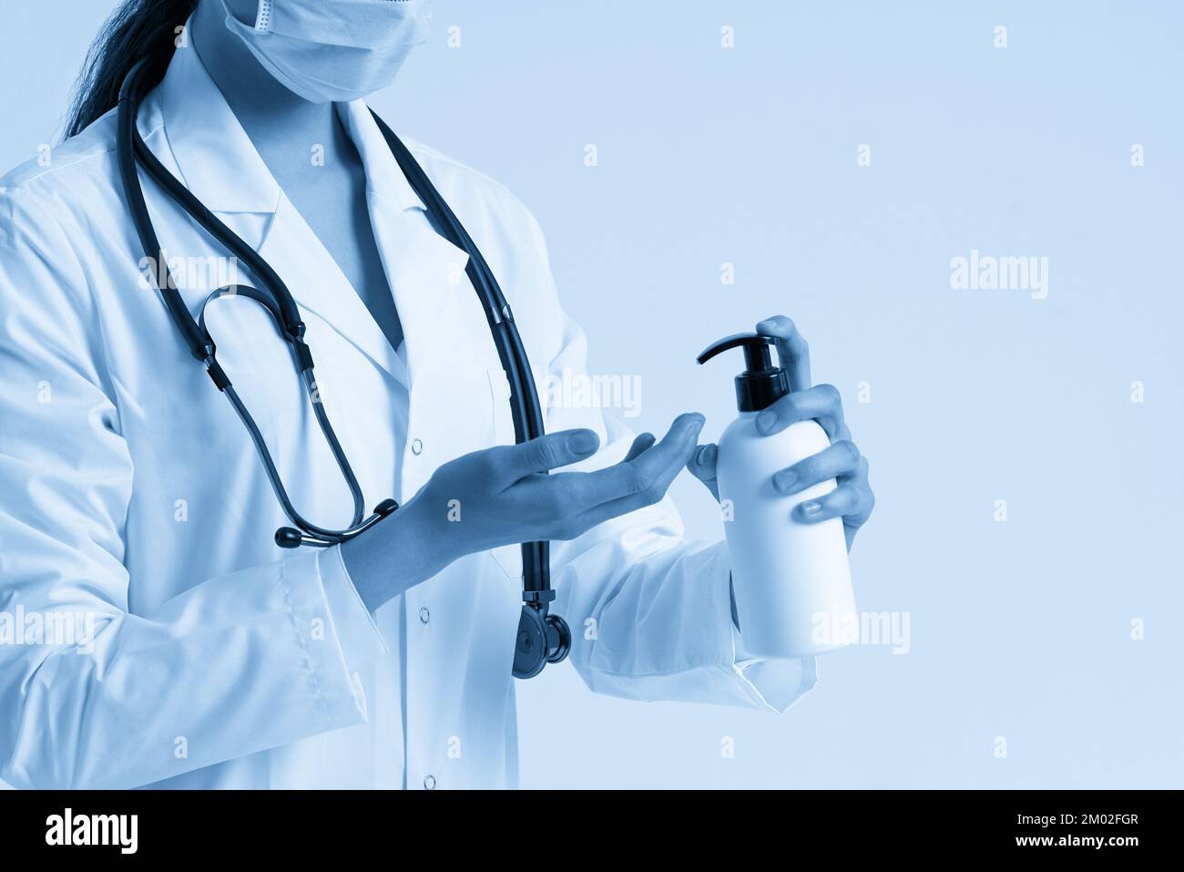 doctor applying antibacterial spray on hand on white background Stock ...