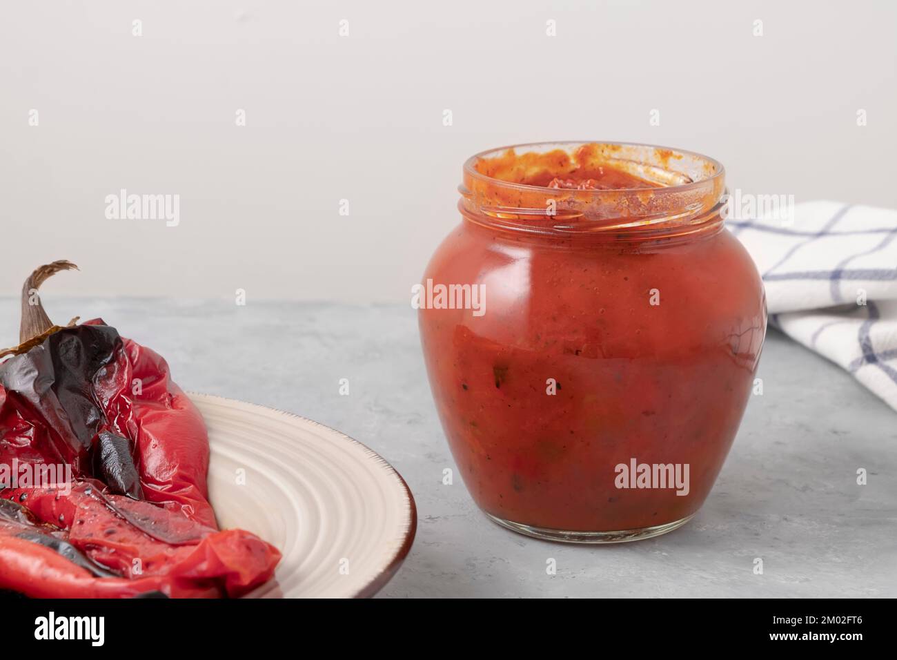 Glass jar of delicious Ljutenica made of roasted bell peppers on