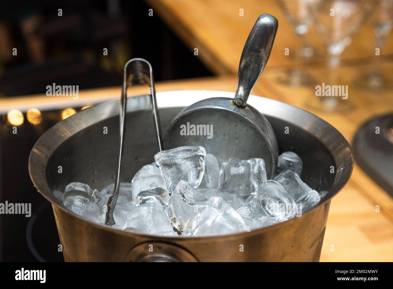 Metal ice bucket for cocktails with large ice cubes with tongs and