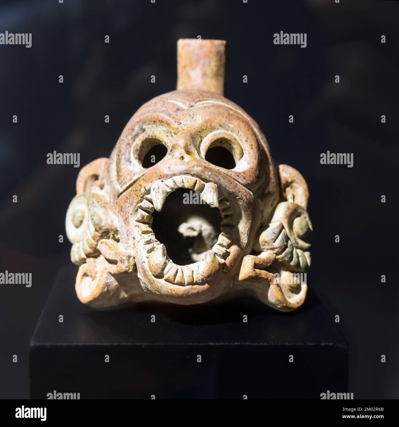 An Aztec death whistle in the shape of a human skull.  When blown, a death whistle emits a realistic shriek, or scream.  It is thought to have been us Stock Photo