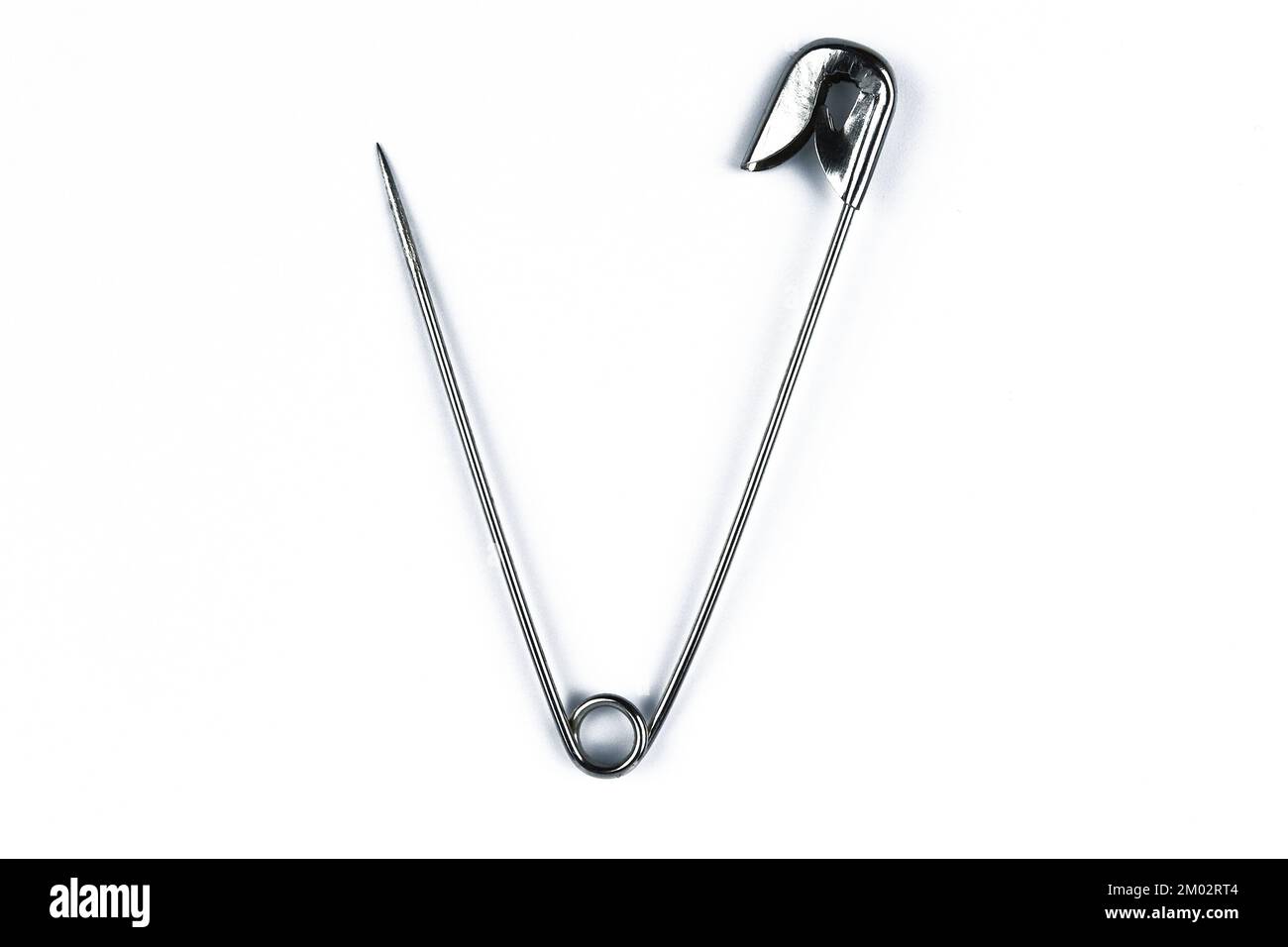 Open safety pin isolated on white background Stock Photo Alamy