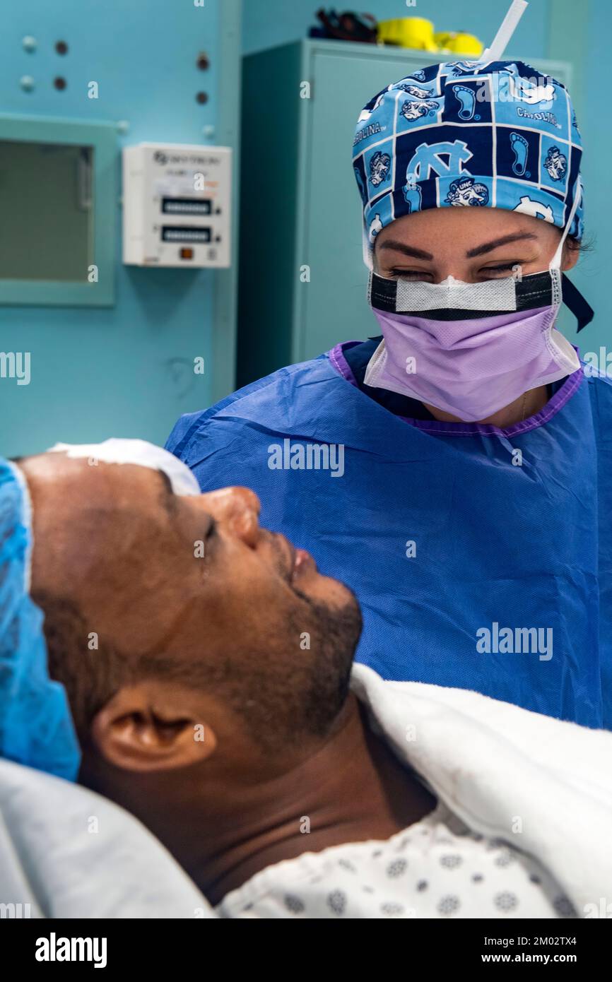 Doctor speaks with eye surgery patient in hospital. Stock Photo