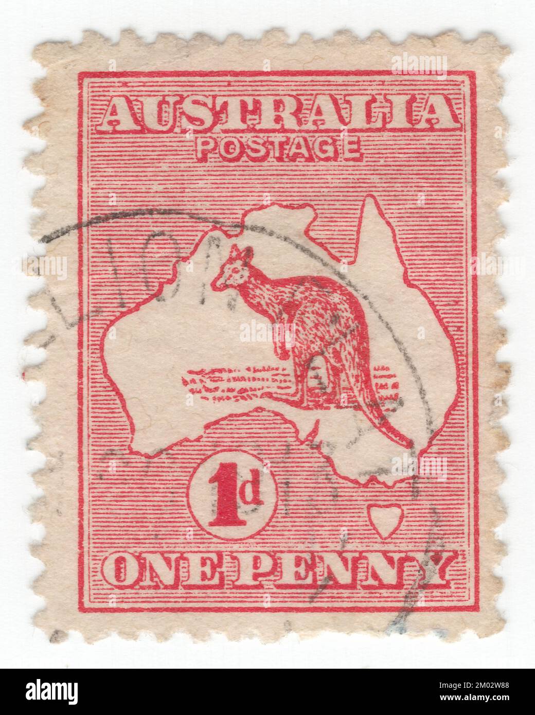 AUSTRALIA — 1913: An 1 pence carmine postage stamp depicting Kangaroo and Map of Australia. Australia is the oldest, flattest, and driest inhabited continent, with the least fertile soils. It is a megadiverse country, and its size gives it a wide variety of landscapes and climates, with deserts in the centre, tropical rainforests in the north-east, and mountain ranges in the south-east. The kangaroo is a recognizable symbol of Australia. First Australian postage stamps issue. The kangaroo and emu feature on the Australian coat of arms Stock Photo