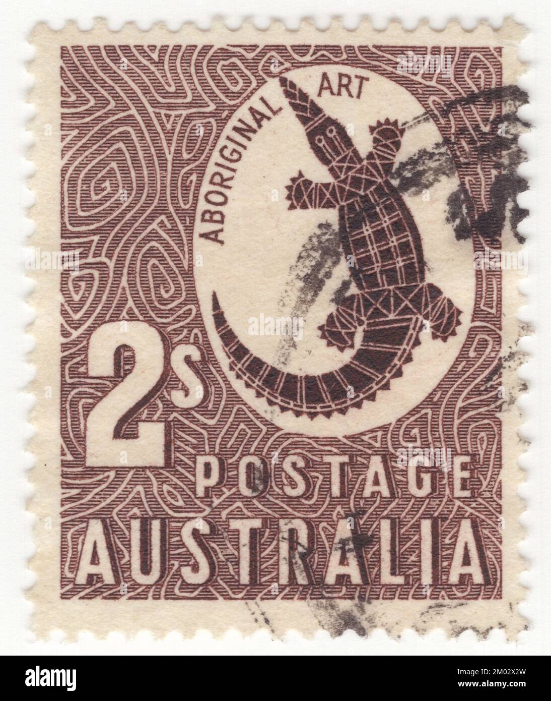 AUSTRALIA — 1948 February 16: An 2 shillings chocolate postage stamp depicting a Сrocodile as an example of Aboriginal art. The freshwater crocodile (Crocodylus johnstoni), also known as the Australian freshwater crocodile, Johnstone's crocodile or the freshie, is a species of crocodile endemic to the northern regions of Australia. Unlike their much larger Australian relative, the saltwater crocodile, freshwater crocodiles are not known as man-eaters, although they bite in self defence, and brief, nonfatal attacks have occurred, apparently the result of mistaken identity Stock Photo