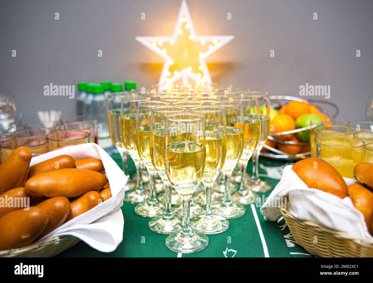Festive table. Russian pies, soft drinks, juices, fruits and champagne in glasses. Stock Photo