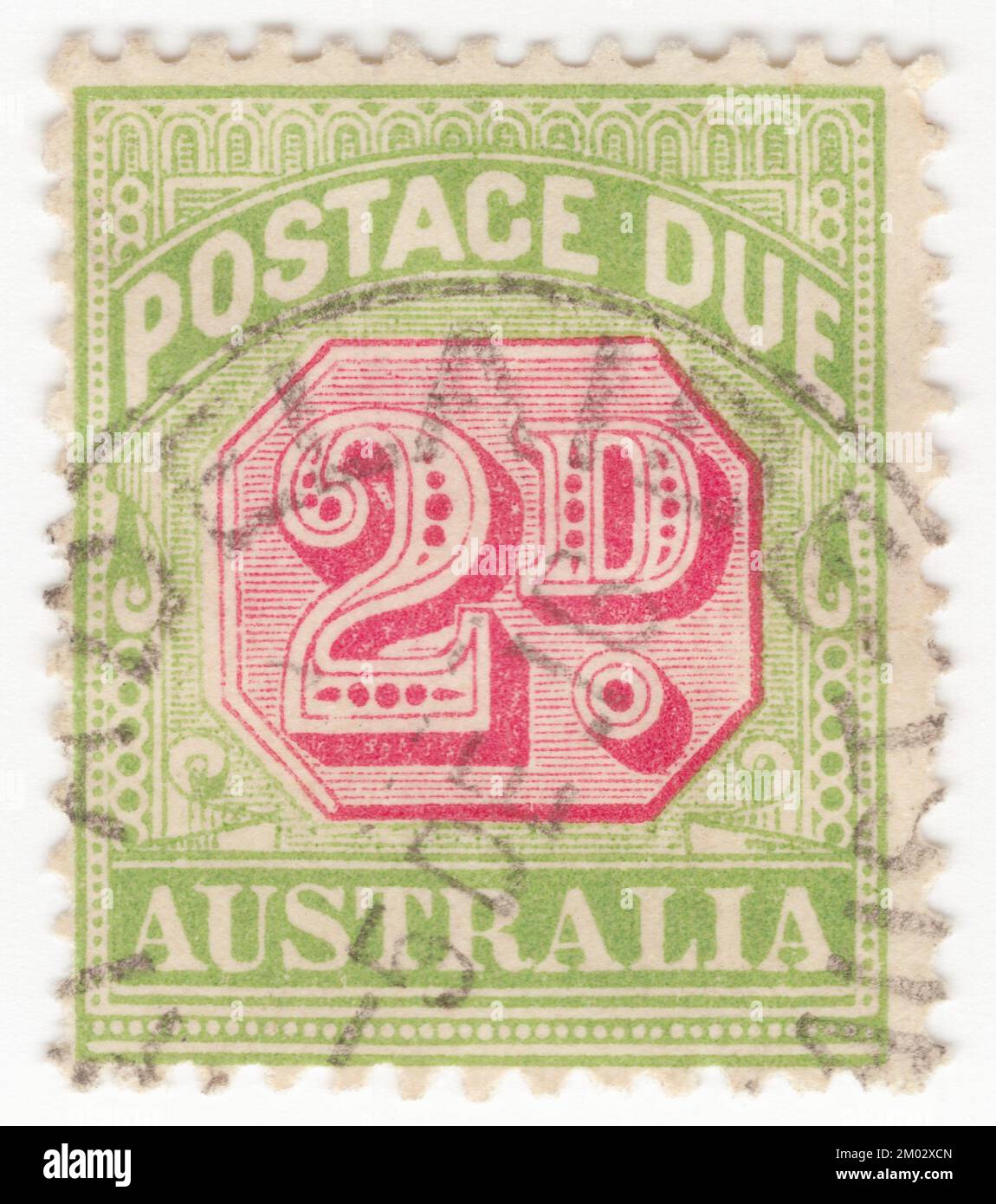 AUSTRALIA — 1909: An 1 pence green and carmine Postage Due stamp depicting Numeral and ornament. Australia, officially the Commonwealth of Australia, is a sovereign country comprising the mainland of the Australian continent, the island of Tasmania, and numerous smaller islands. Australia is the oldest, flattest, and driest inhabited continent, with the least fertile soils. It is a megadiverse country, and its size gives it a wide variety of landscapes and climates, with deserts in the centre, tropical rainforests in the north-east, and mountain ranges in the south-east Stock Photo