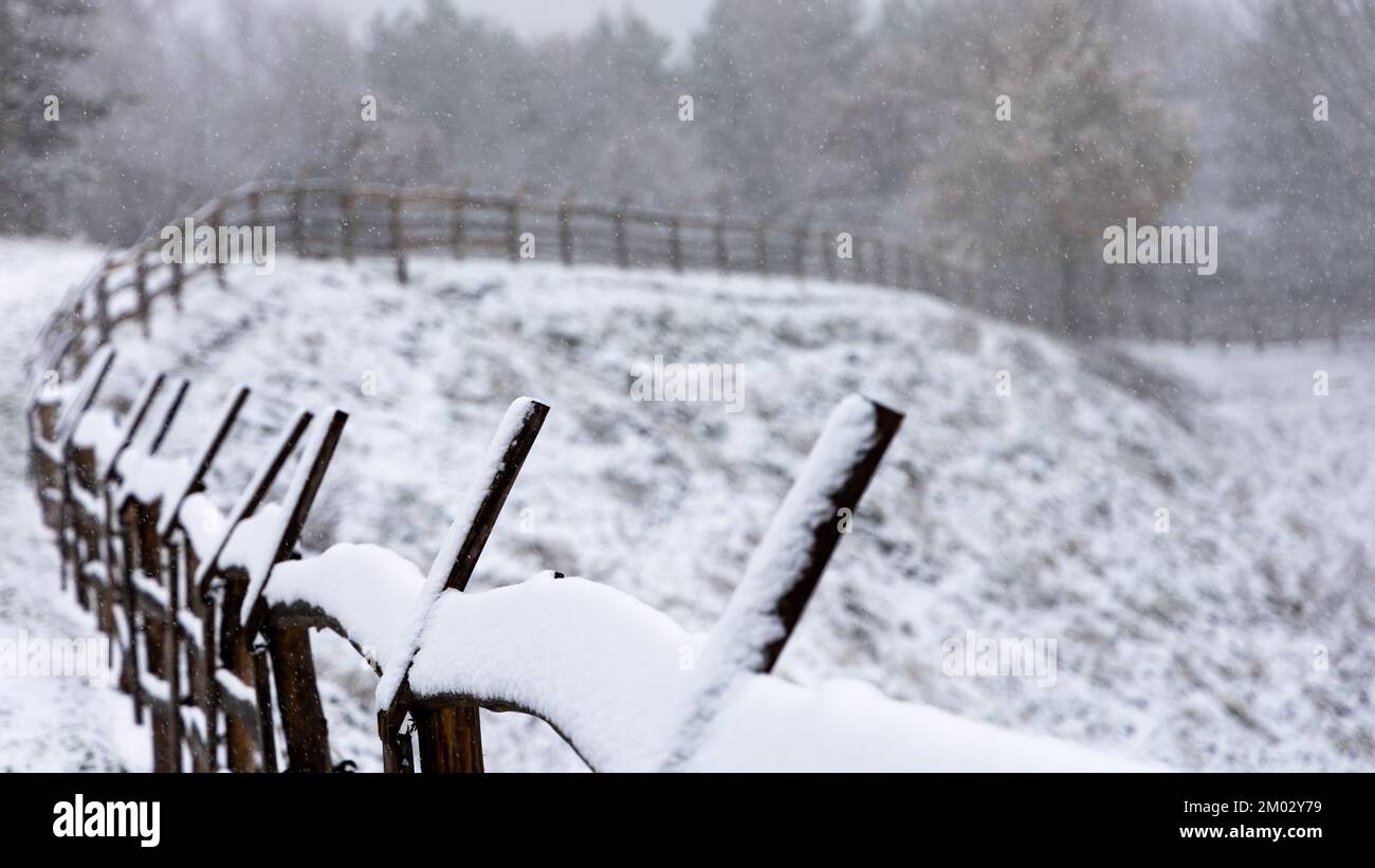 Wooden fence covered with a thin layer of the first snow. Rural ...