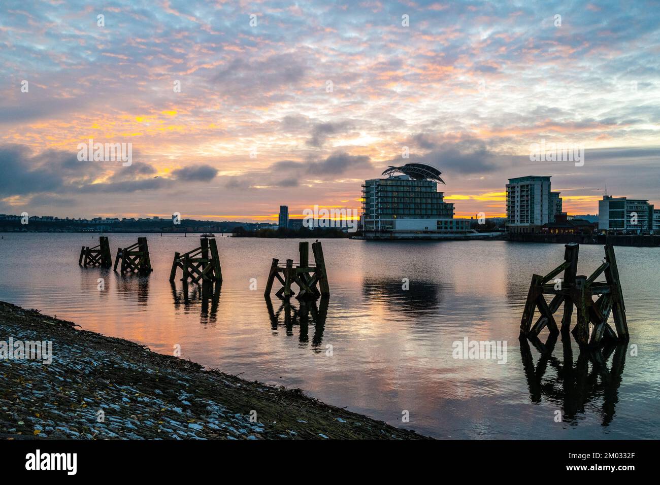 Cardiff Bay at Sunset, looking towards Penarth with the remains of the old wooden jetties in the foreground. Stock Photo