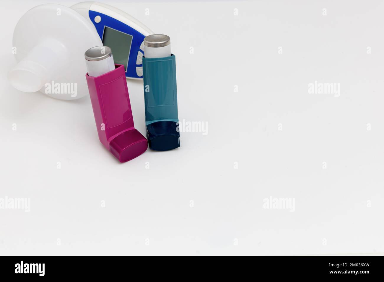 Asthma medications inhalers and peak flow meter on a white background