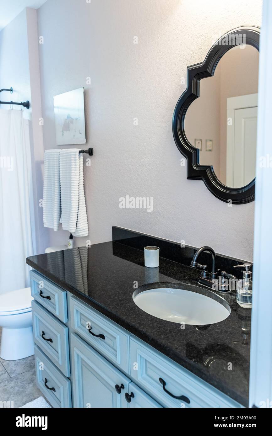 Single downstairs black granity vanity guest bathroom Stock Photo