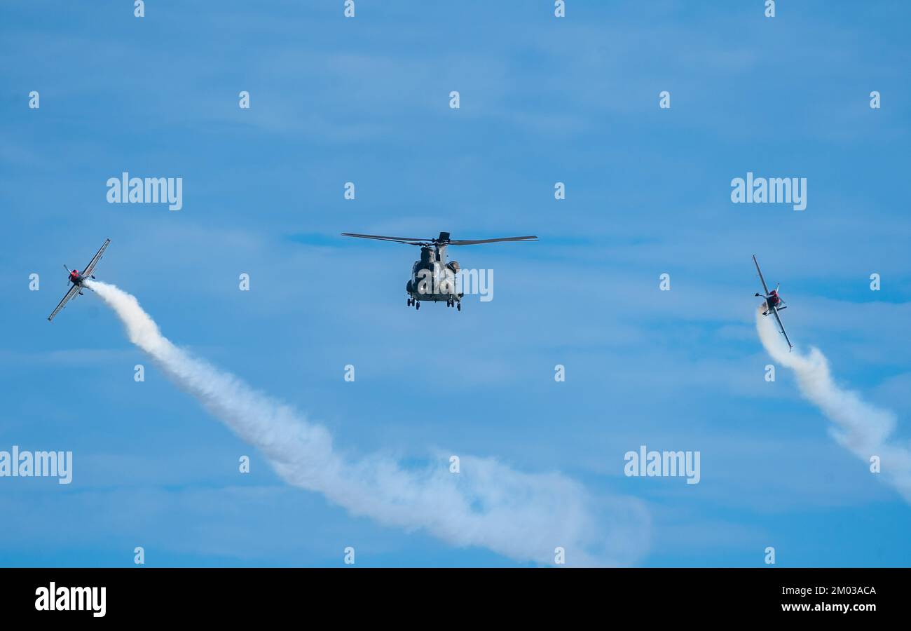 Chinook Helicopter And Extra 300 Aircraft Flyby Bournemouth Air Festival 2022 Stock Photo