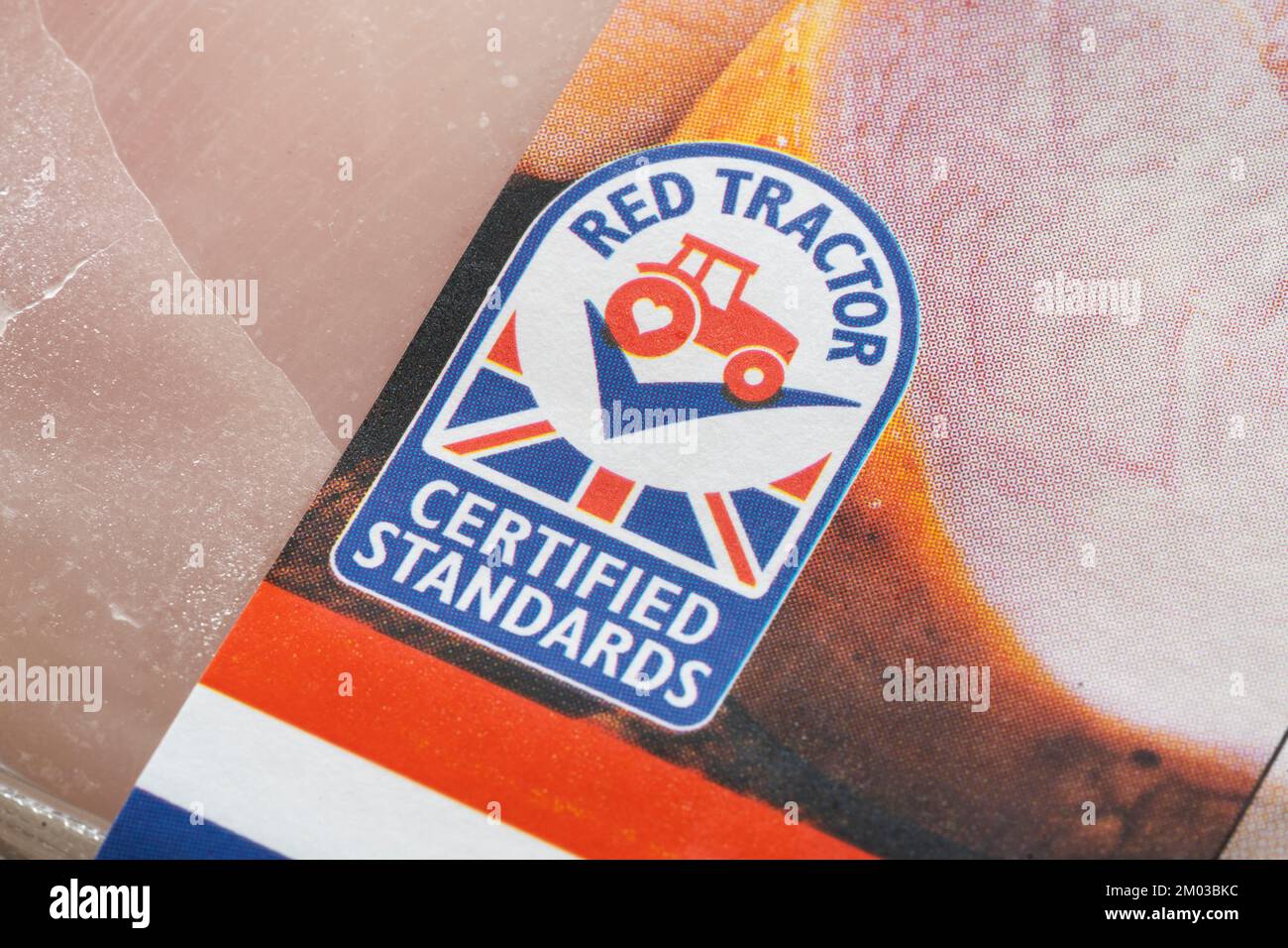 Closeup on Red Tractor logo. Assured Food Standards is a UK company which licenses the Red Tractor quality mark, a product certification programme Stock Photo