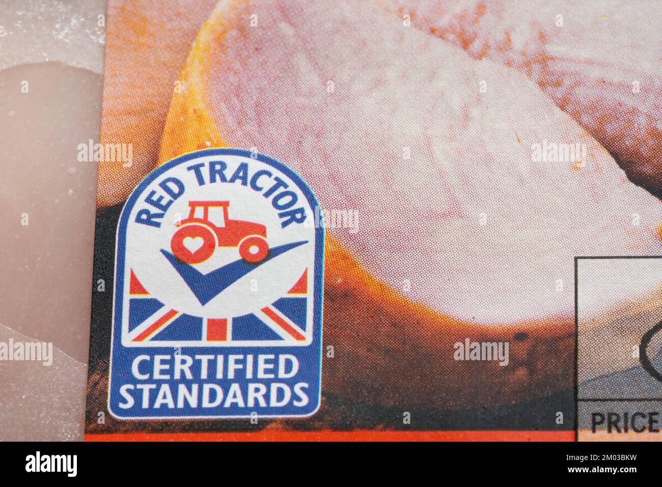 Closeup on Red Tractor logo. Assured Food Standards is a UK company which licenses the Red Tractor quality mark, a product certification programme Stock Photo