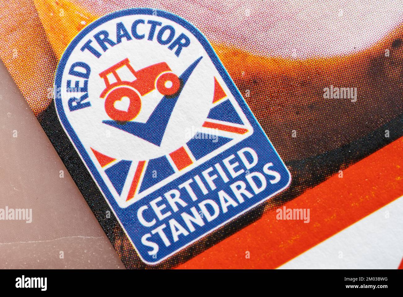 Closeup on Red Tractor logo. Assured Food Standards is a UK company which licenses the Red Tractor quality mark, a product certification programme Stock Photo