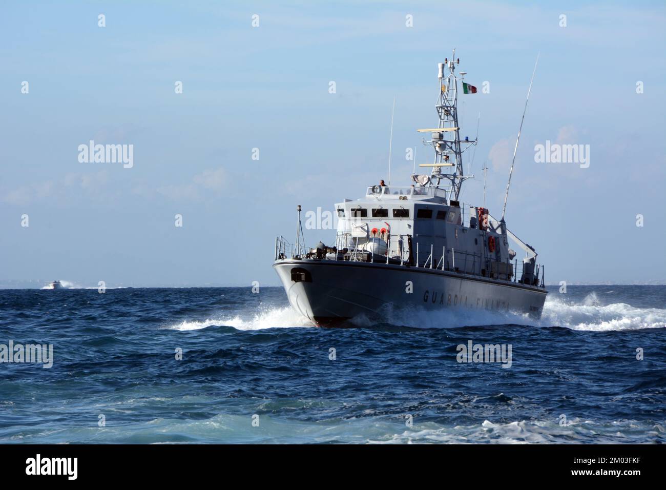 And Italian Coast Guard (Guardia Costiera) navy ship patrolling the Mediterranean waters of the Amalfi Coast, near Sorrento, Campania, Italy. Stock Photo