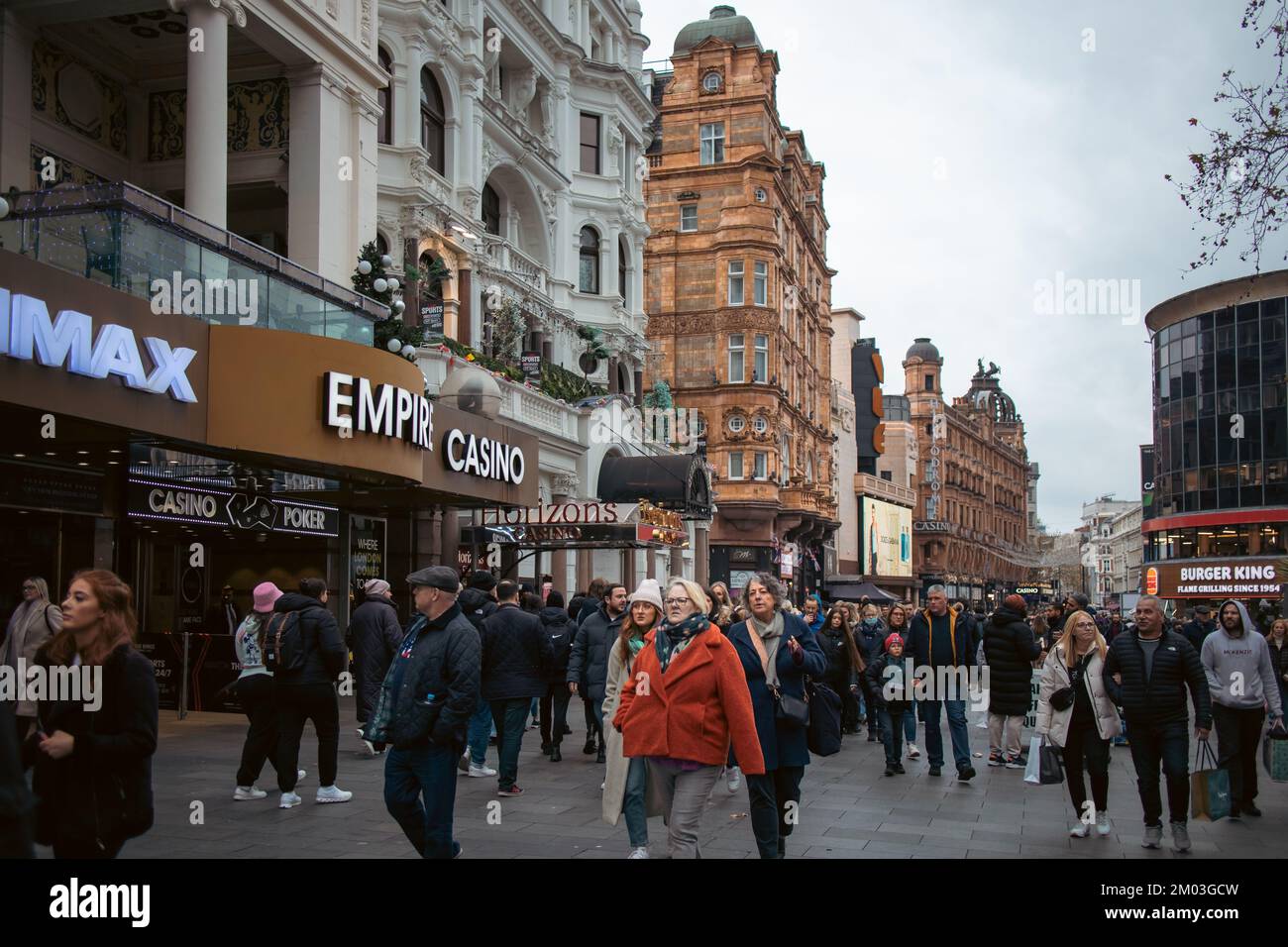 London, December 3rd 2022 - Passers by at Leicester Square Christmas Market Stock Photo