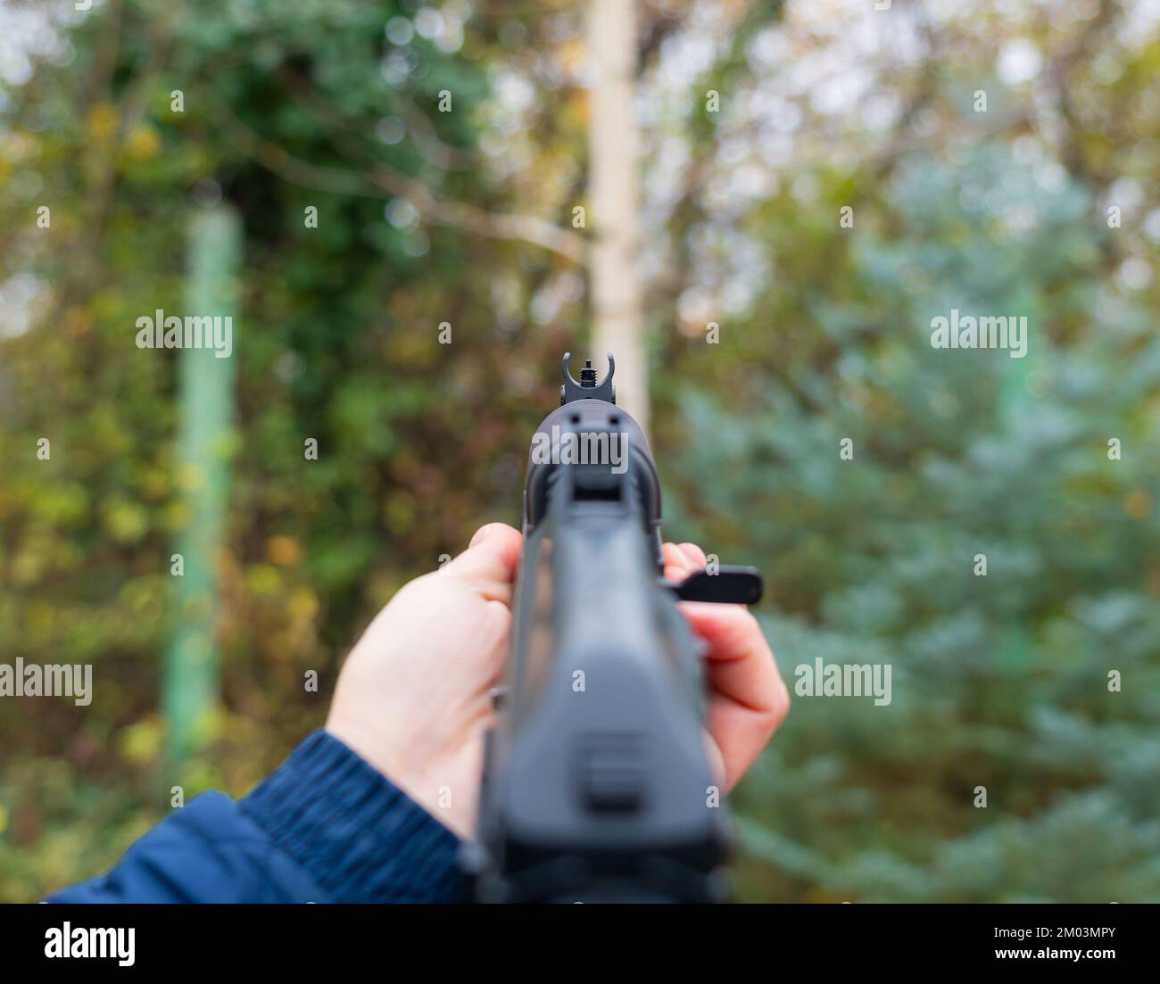 Hand holding Kalashnikov assault rifle first person view Stock Photo