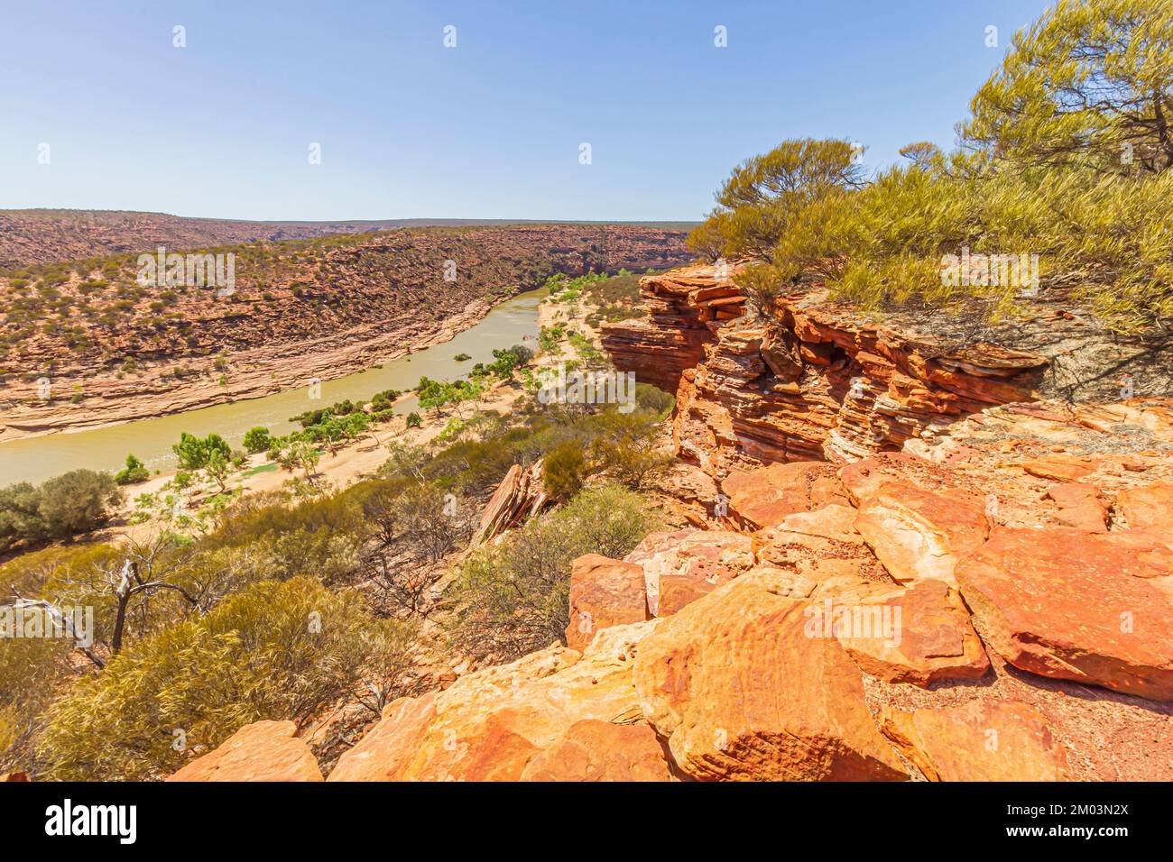 Rugged rocky cliff with layered sandstone formation over Murchison River Gorge along the Nature Window Trail in Kalbarri National Park, Australia. Stock Photo