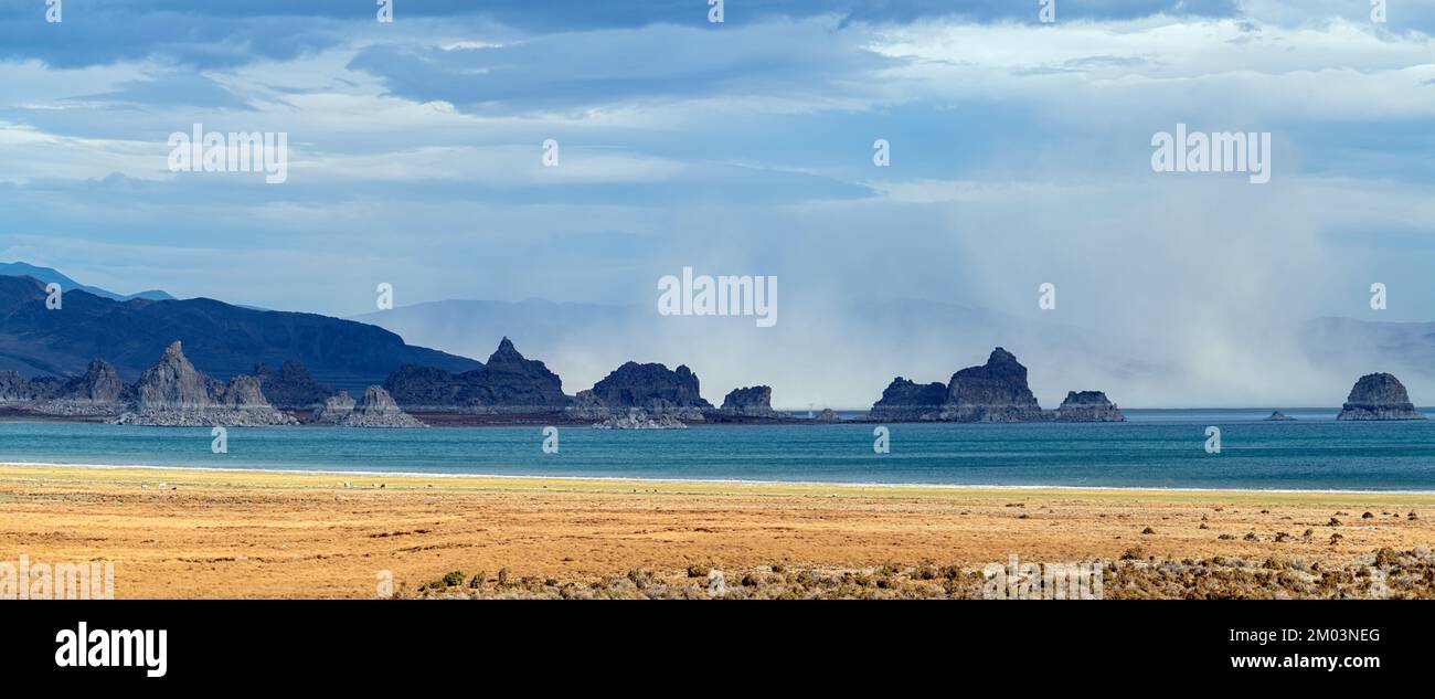 Panorama of a dust storm blowing across rock formation in Pyramid Lake
