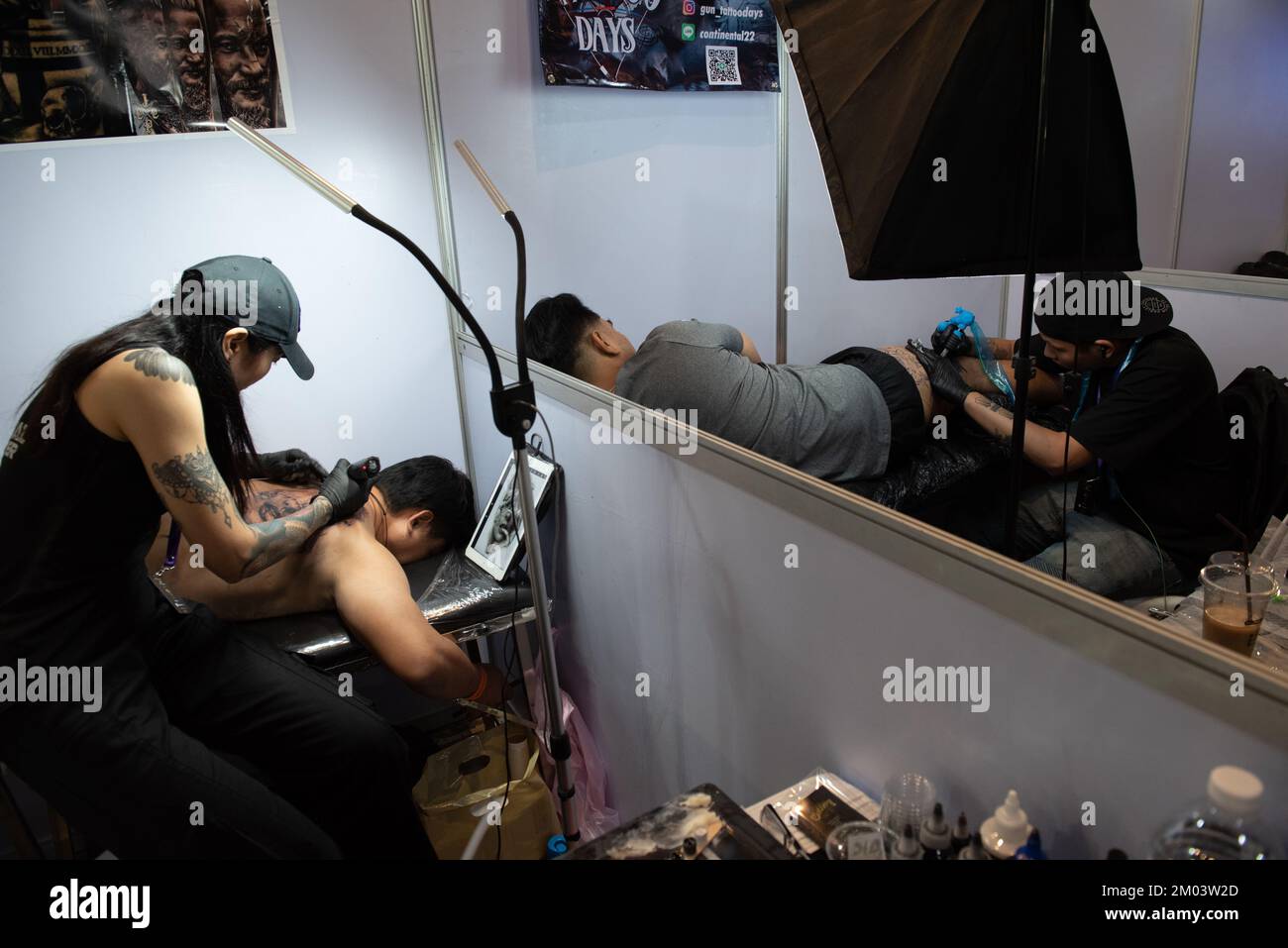 Bangkok, Thailand. 03rd Dec, 2022. A tattoo artist puts tattoos on the body of people who are