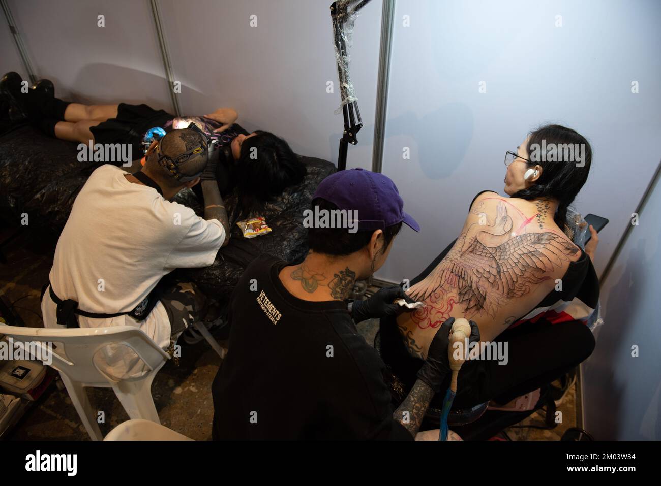 Bangkok, Thailand. 03rd Dec, 2022. A tattoo artist puts tattoos on the body of people who are