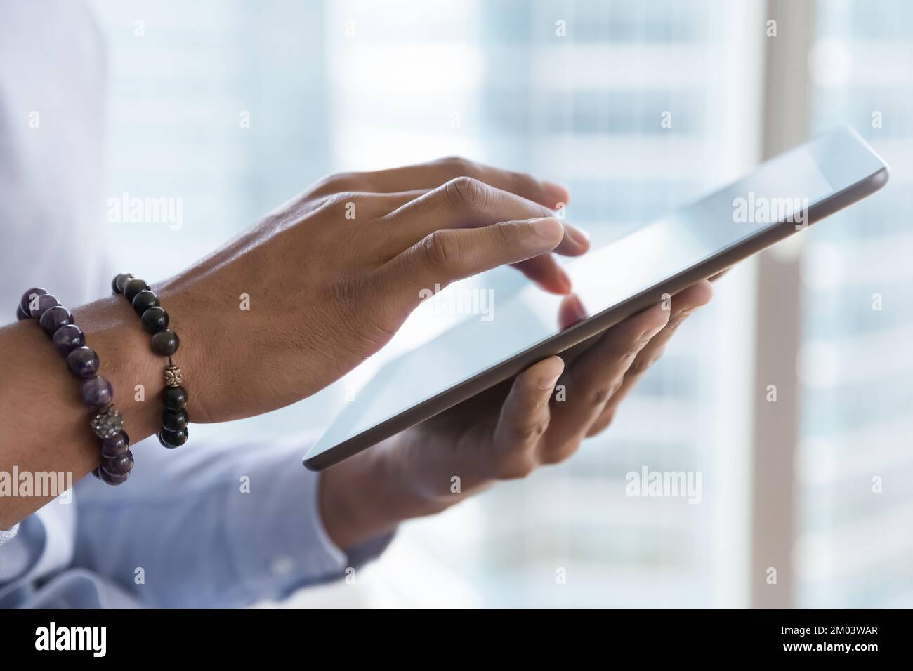 Dark skinned business man using online app, virtual service Stock Photo