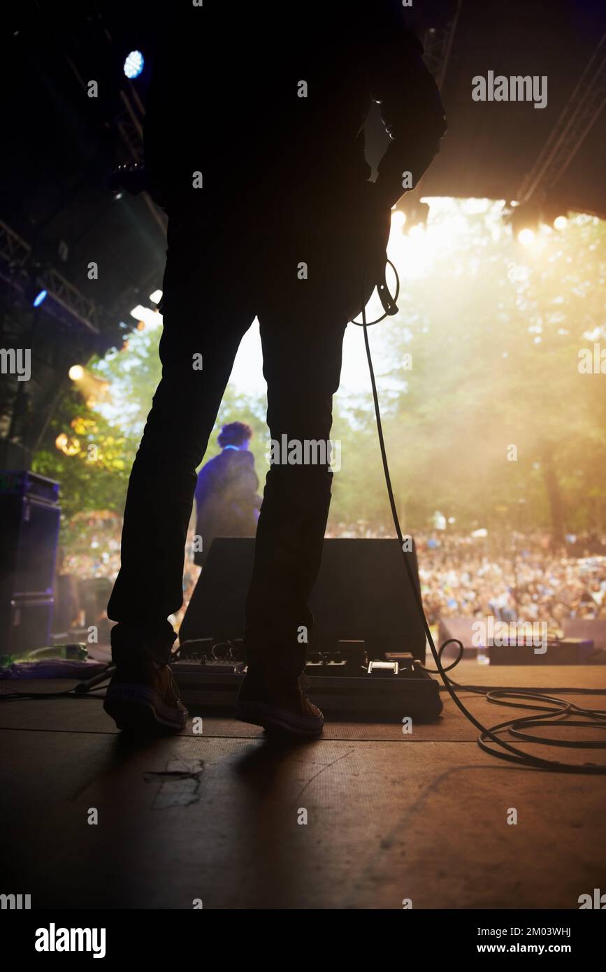 Ready to rock. a musicians feet on stage at an outdoor music festival. Stock Photo