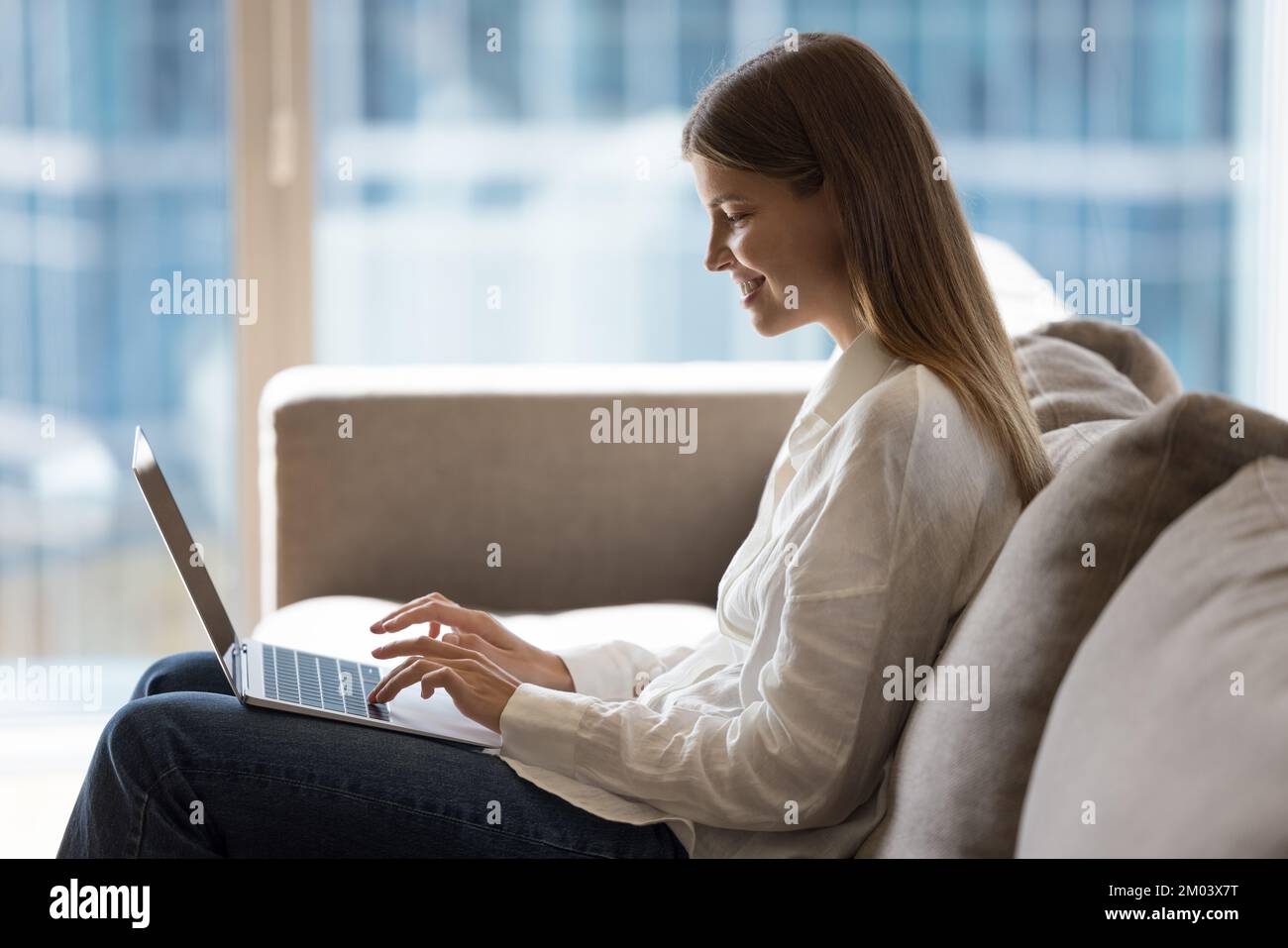 Happy cheerful pretty young freelance business woman working from home Stock Photo
