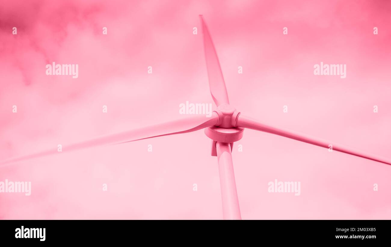 Color of year 2023 Viva Magenta. Image with wind generator for electricity is toned in pantone color of viva magenta. New Fashion colour. Windmill for Stock Photo