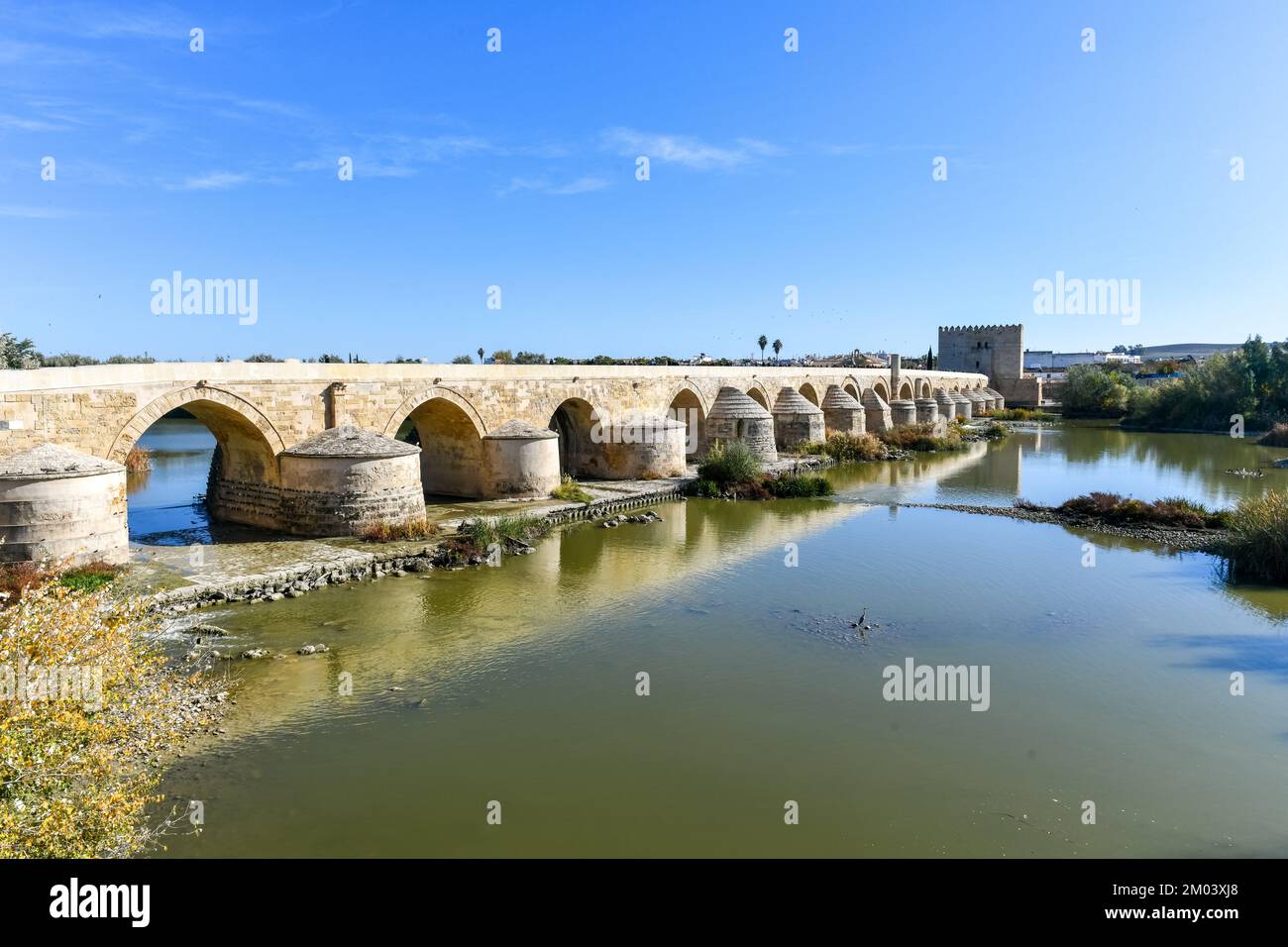 View of the Roman Bridge, a stone bridge that spans the river Guadalquivir in Cordoba, Spain. Stock Photo