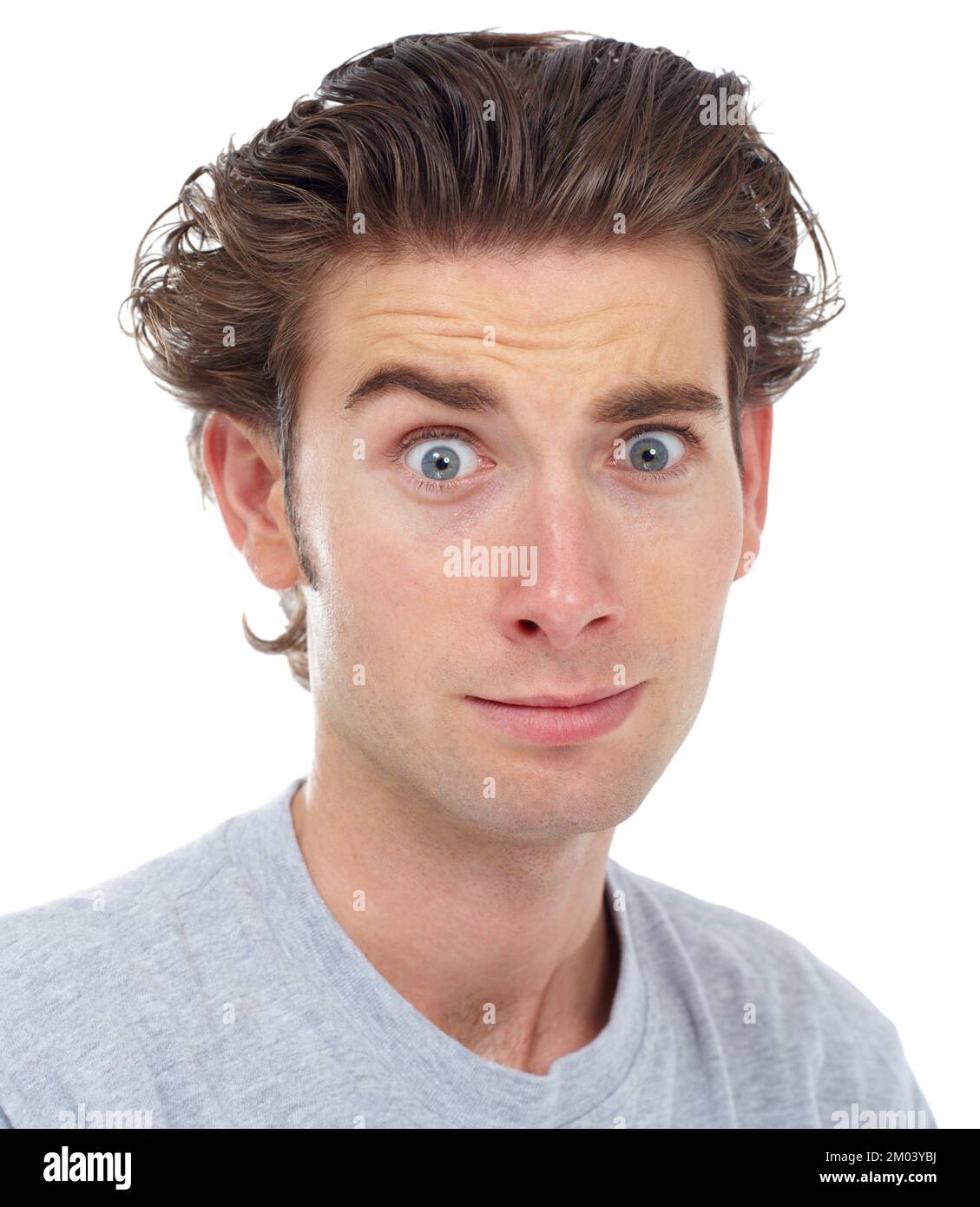 Oops. Young man looking at the camera with his eyebrows raised Stock