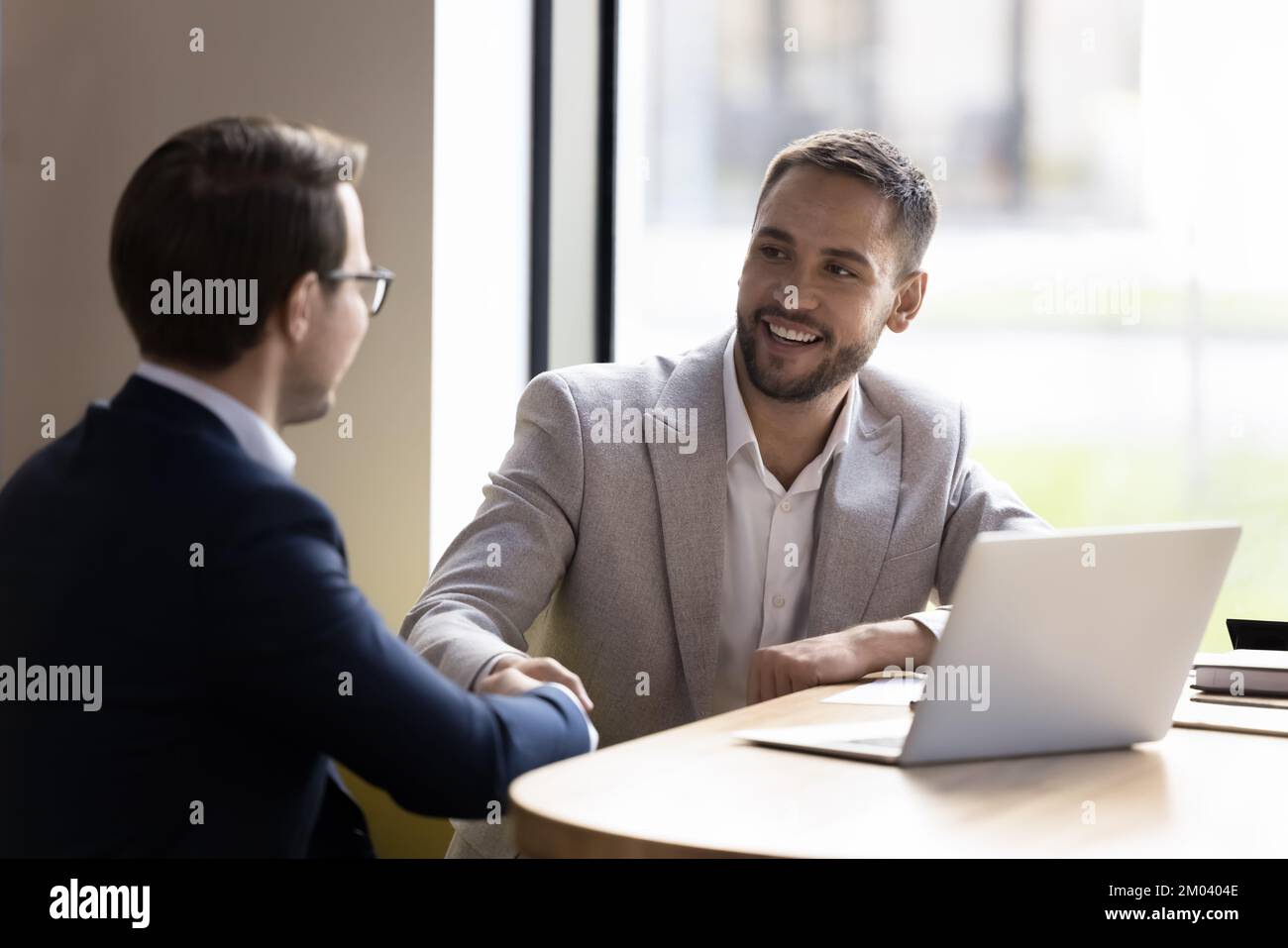 Two business partners finish successful negotiations with shake hands Stock Photo