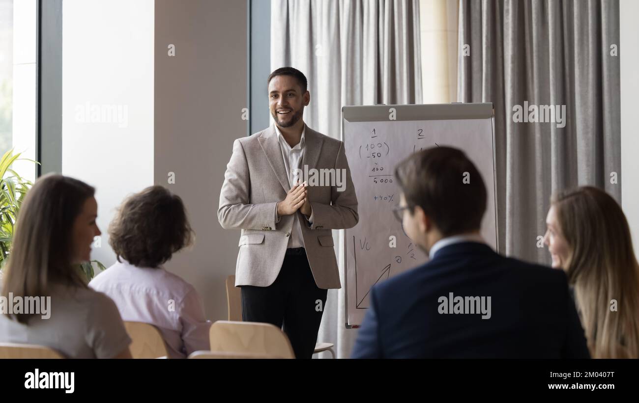 Business trainer gives flip chart presentation to clients Stock Photo ...
