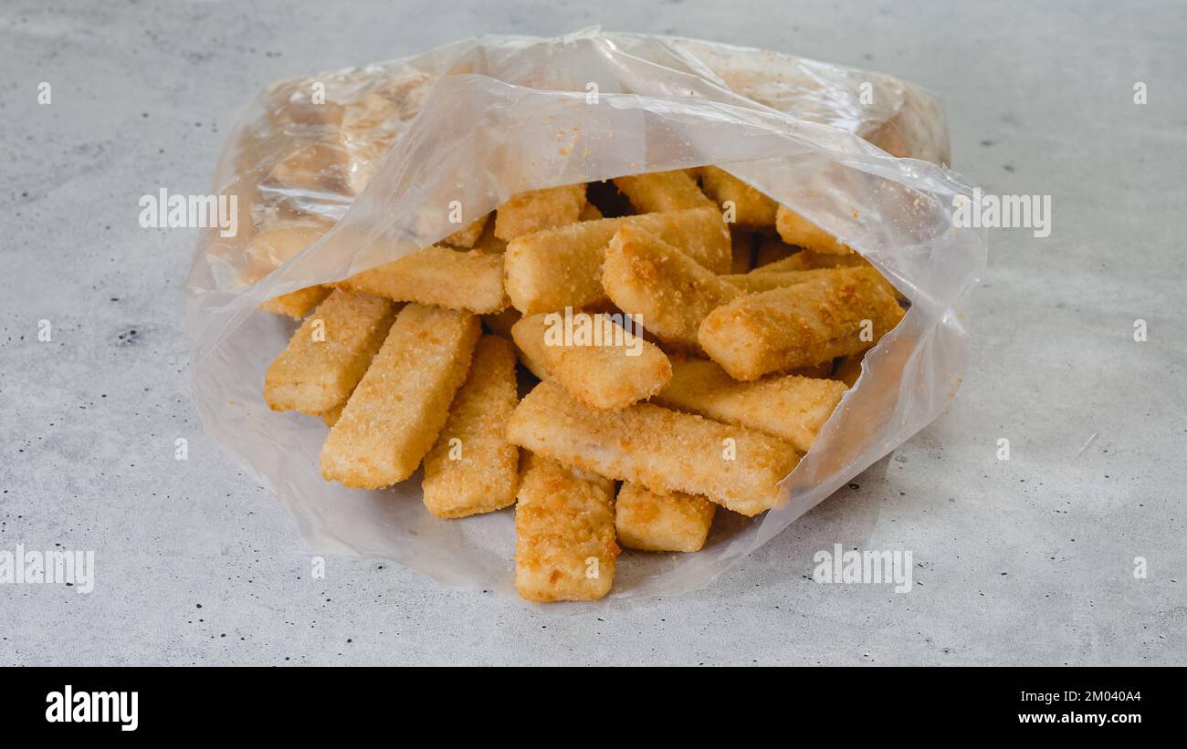 Breaded fish sticks frozen. Plastic bag of fish sticks in a crunchy