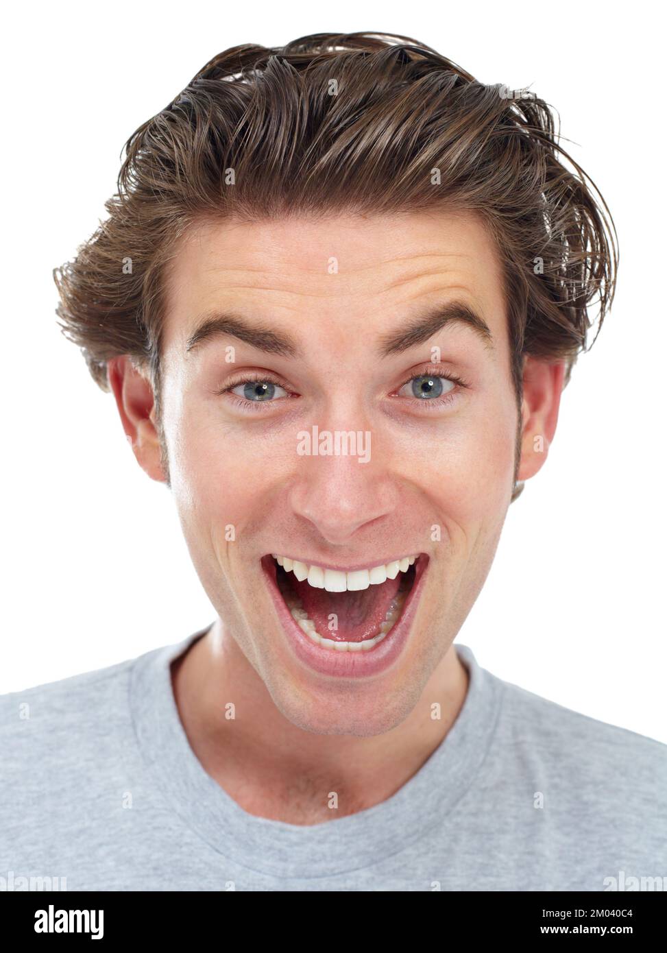 Getting some great news. Happy young man smiling broadly at the camera with his eyebrows raised